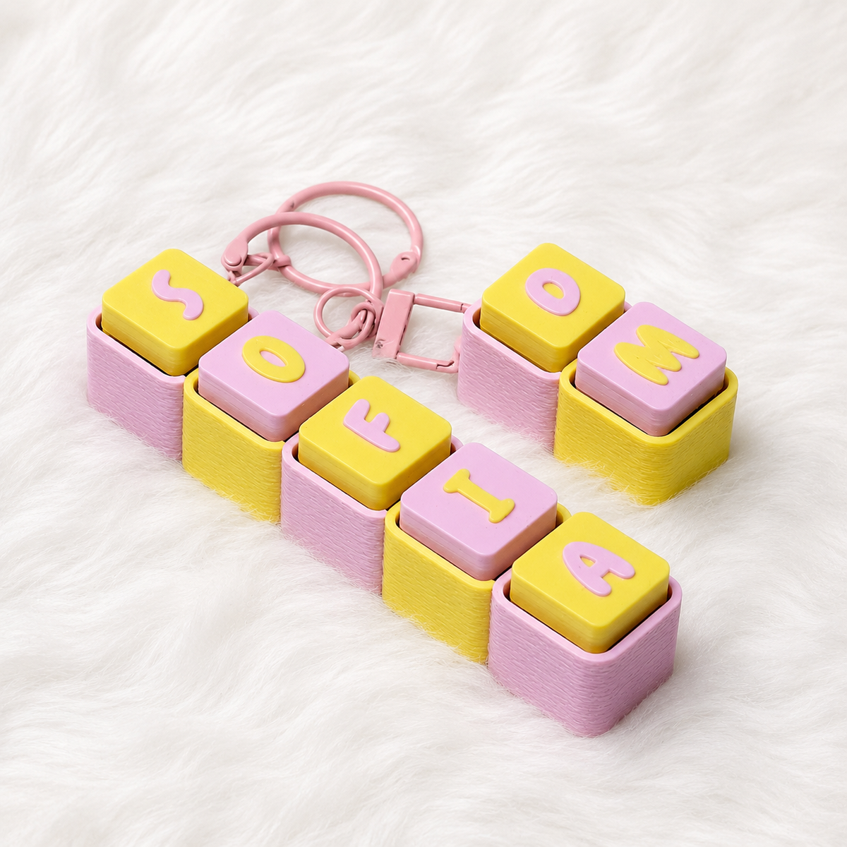 Pastel pink and yellow personalized name keychain spelling SOFIE