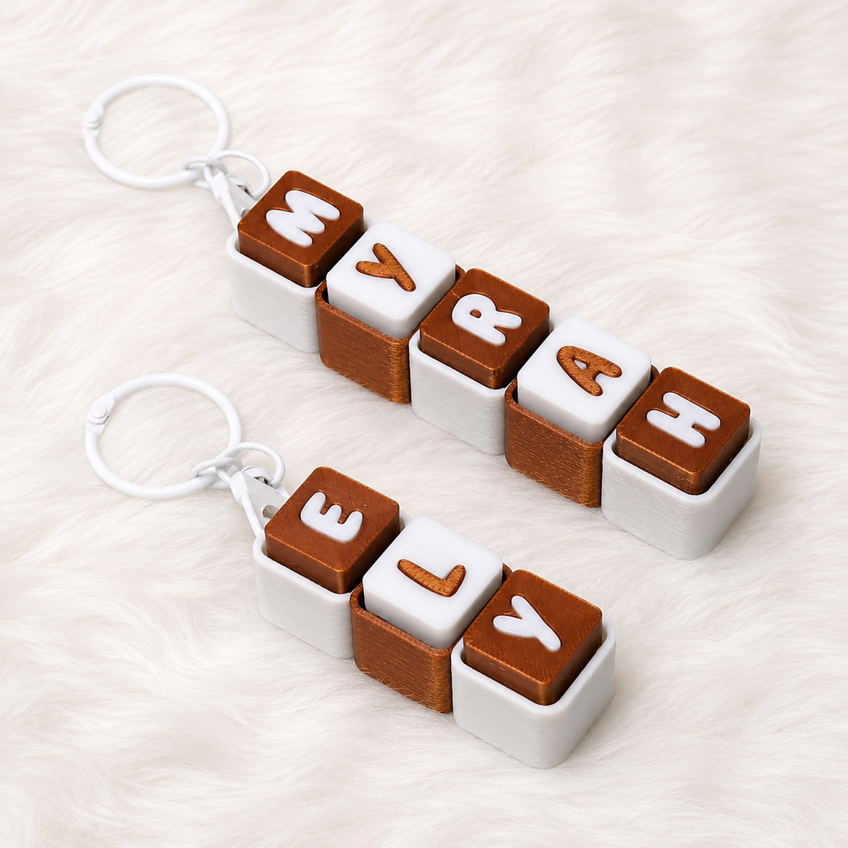 Personalized copper and white name keychains spelling MYRAH and ELY