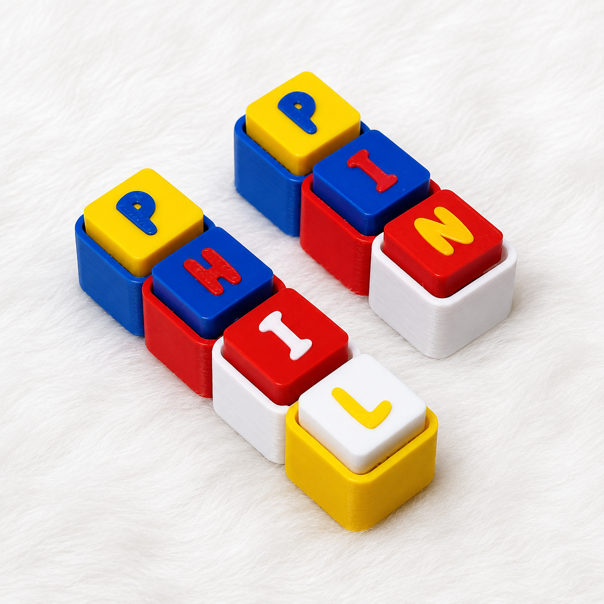 Personalized 3D printed name keychain in Philippine flag colors, showing colorful letter blocks on a white background