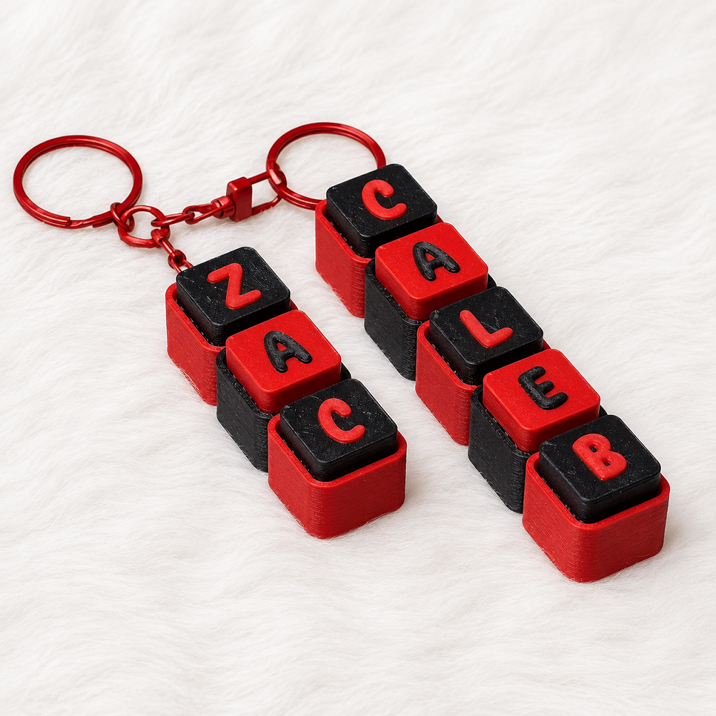 Personalized red and black name keychains spelling ZAC and CALEB