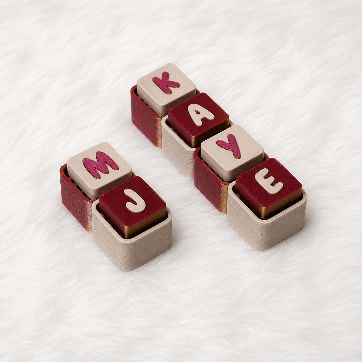 Personalized red and white name keychains spelling MYRAH and KAYE