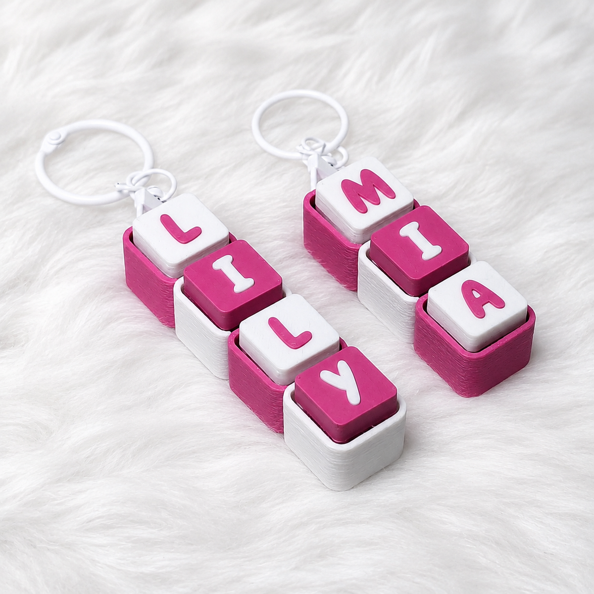 Pink and white personalized name keychains spelling LILY and MIA